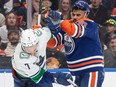 Vancouver Canucks' Carson Soucy (7) and Edmonton Oilers' Evander Kane (91) rough it up during second period NHL action in Edmonton, Saturday, April 13, 2024.