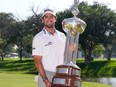 Davis Riley of the United States poses for a photo with the Leonard Trophy after winning the Charles Schwab Challenge at Colonial Country Club on May 26, 2024 in Fort Worth, Texas.