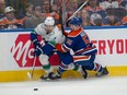 Dylan Holloway (55) of the Edmonton Oilers, checks Quinn Hughes (43) of the Vancouver Canucks at Rogers Place in Edmonton on May 12, 2024.