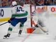 Goalie Stuart Skinner (74) of the Edmonton Oilers makes the save on a shot from Quinn Hughes (43) of the Vancouver Canucks at Rogers Place in Edmonton on Sunday, May 12, 2024.