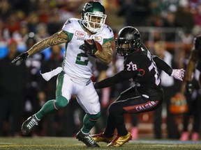 A career that started on the practice roster has earned Chad Owens a spot in the Canadian Football Hall of Fame. Owens, left, runs the ball past Calgary Stampeders' Brandon Smith during first half CFL football action in Calgary, Friday, Oct. 20, 2017.THE CANADIAN PRESS/Jeff McIntosh