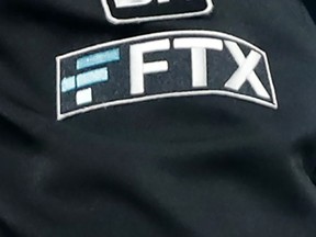The FTX logo appears on umpire Jansen Visconti's jacket at a baseball game with the Minnesota Twins on Sept. 27, 2022, in Minneapolis.