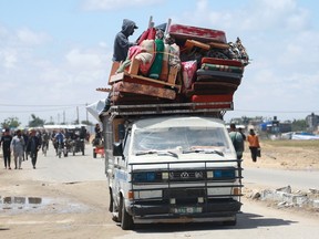 Displaced Palestinians who left with their belongings from Rafah in the southern Gaza Strip following an evacuation order by the Israeli army, arrive to Khan Yunis on May 6, 2024.