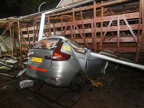 A car crushed by the collapsed structure of a billboard and metal girder in Mumbai, India, on Monday, May 13, 2024.