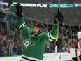 Dallas Stars left wing Jason Robertson (21) celebrates after scoring a goal during a power play as Philadelphia Flyers' Nick Seeler (24) skates away in the first period of an NHL hockey game, in Dallas, Thursday, April 6, 2023.