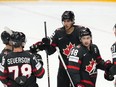Dylan Cozens, middle, celebrates with teammates after scoring against Austria at the World Championship in Prague, Czech Republic, Tuesday, May 14, 2024.