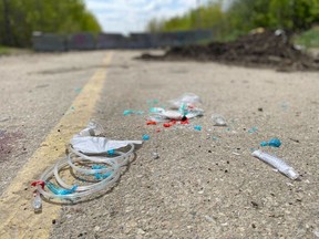 Supplies from first responders litter the road near the area of 137 Avenue and 184 Street where a 15-year-old boy died on Tuesday, May 21, 2024, in Edmonton. City police investigators have arrested a man in connection to the death of the teen.