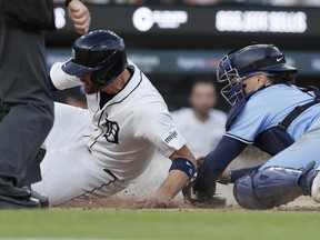 Tigers' Carson Kelly is tagged out by Blue Jays catcher Danny Jansen while trying to score on a single in the sixth inning at Comerica Park on May 23, 2024 in Detroit.