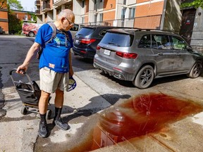 Mohammad Mobed walks past a puddle stained with the blood of stabbing victims next to the building where he lives in the Plateau May 22, 2024. Three people died, including a 15-year-old boy.