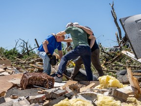 Billy Moles (left) is prayed for after his home was destroyed by a tornado on May 7, 2024 in Barnsdall, Oklahoma.