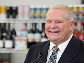 Ontario Premier Doug Ford attends a press availability at a convenience store in Toronto, Thursday, Dec. 14, 2023. Ontario is speeding up its expansion of alcohol sales in the province, and it comes with $225 million in funding for The Beer Store.