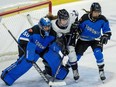 Toronto goaltender Kristen Campbell (50) battles for position with Minnesota's Abby Boreen (24) as Toronto Kali Flanagan (6) jumps in during second period PWHL playoff hockey action in Toronto on Friday, May 10, 2024.