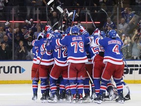 New York Rangers celebrate after Barclay Goodrow's game-winning goal during overtime against the Florida Panthers in Game 2 of the Eastern Conference Final of the 2024 Stanley Cup Playoffs at Madison Square Garden on May 24, 2024 in New York City.