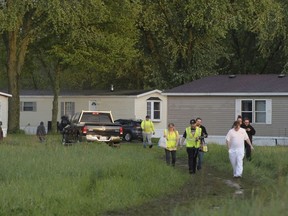 People leave after a tornado swept through the area of the Pavilion Estates mobile home park, in Kalamazoo, Mich., Tuesday, May 7, 2024.