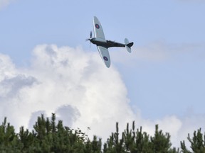 A Spitfire RAF plane flies past ahead of the British Formula One Grand Prix at the Silverstone racetrack, England, Sunday, Aug. 2, 2020.