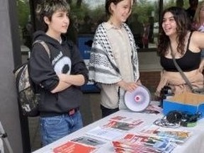 Oakville High School students took the day off to promote communism at a table outside Oakville’s city hall on May 15, 2022. (Joe Warmington photo)