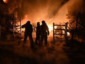 Ukrainian firefighters work to extinguish a fire at the site of a drone attack on industrial facilities in Kharkiv on May 4, 2024.
