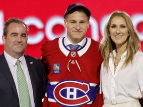 Ivan Demidov (centre) poses after being selected by the Montreal Canadiens during the first round of the NHL draft on June 28, 2024, in Las Vegas. The announcement was made by singer Celine Dion (right).