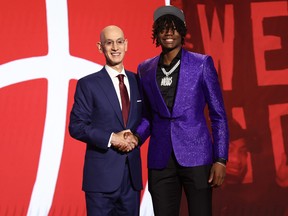 Ja'Kobe Walter shakes hands with NBA commissioner Adam Silver after being drafted 19th overall by the Toronto Raptors.