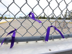 Ribbons tied to a chain-link fence at the outdoor basketball court and rink where Danillo Glenn was killed.