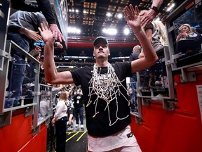 Zach Edey of the Purdue Boilermakers celebrates with fans after defeating the Tennessee Volunteers in the Elite 8 round of the NCAA Men's Basketball Tournament at Little Caesars Arena on March 31, 2024, in Detroit.
