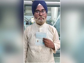 Guru Sewak Singh, 24, is pictured holding a passport of a 67-year-old man.