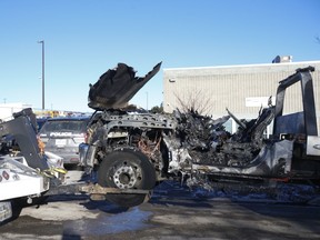 A burnt flatbed tow truck is removed from a street in Scarborough on Jan. 23, 2021.