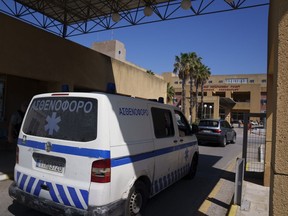 An ambulance drives through the entrance of a state-run hospital on the island of Rhodes.