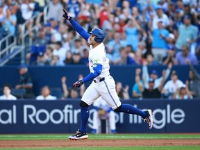 Blue Jays' George Springer celebrates after hitting a three-run home run in the first inning against the New York Yankees at Rogers Centre on June 27, 2024 in Toronto.