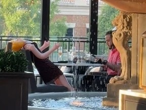 Man sitting in restaurant opposite inflatable sex doll.