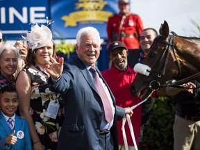 Frank Stronach poses with horse "Holy Helena" of Stronach Stables, after winning the 158th running of the Queen's Plate horse race at Woodbine Race Track, in Toronto on Sunday, July 2, 2017. A court document shows 91-year-old billionaire businessman Stronach stands accused of sexually assaulting seven additional complainants from 1977 to as recently as February.THE CANADIAN PRESS/Mark Blinch