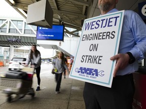 Striking aircraft mechanics are seen on the picket line at Pearson International Airport in Toronto on Saturday, June 29, 2024.
