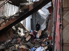 A Palestinian woman surveys the damage to a house following Israeli bombardment at the al-Maghazi Palestinian refugee camp, in the central Gaza Strip on July 15, 2024, amid the ongoing conflict between Israel and the Palestinian Hamas militant group.