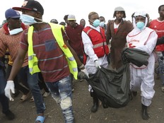 Rescuers carry sacks with human remains after being removed from a quarry in Mukuru Kwa Njenga area in Nairobi, Kenya Saturday, July 13, 2024.