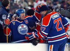 #11 Mark Messier pats #27 Dave Semenko on the head during the Heritage Classic hockey game at Commonwealth Stadium.