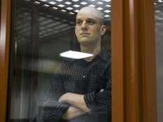 Wall Street Journal reporter Evan Gershkovich stands in a glass cage in a courtroom in Yekaterinburg, Russia, Wednesday, June 26, 2024. Fifteen months after he was arrested in the city of Yekaterinburg on espionage charges, Gershkovich returns there for his trial starting Wednesday, June 26, 2024, behind closed doors. Gershkovich, his employer and the U.S. government deny the charges. (AP Photo)