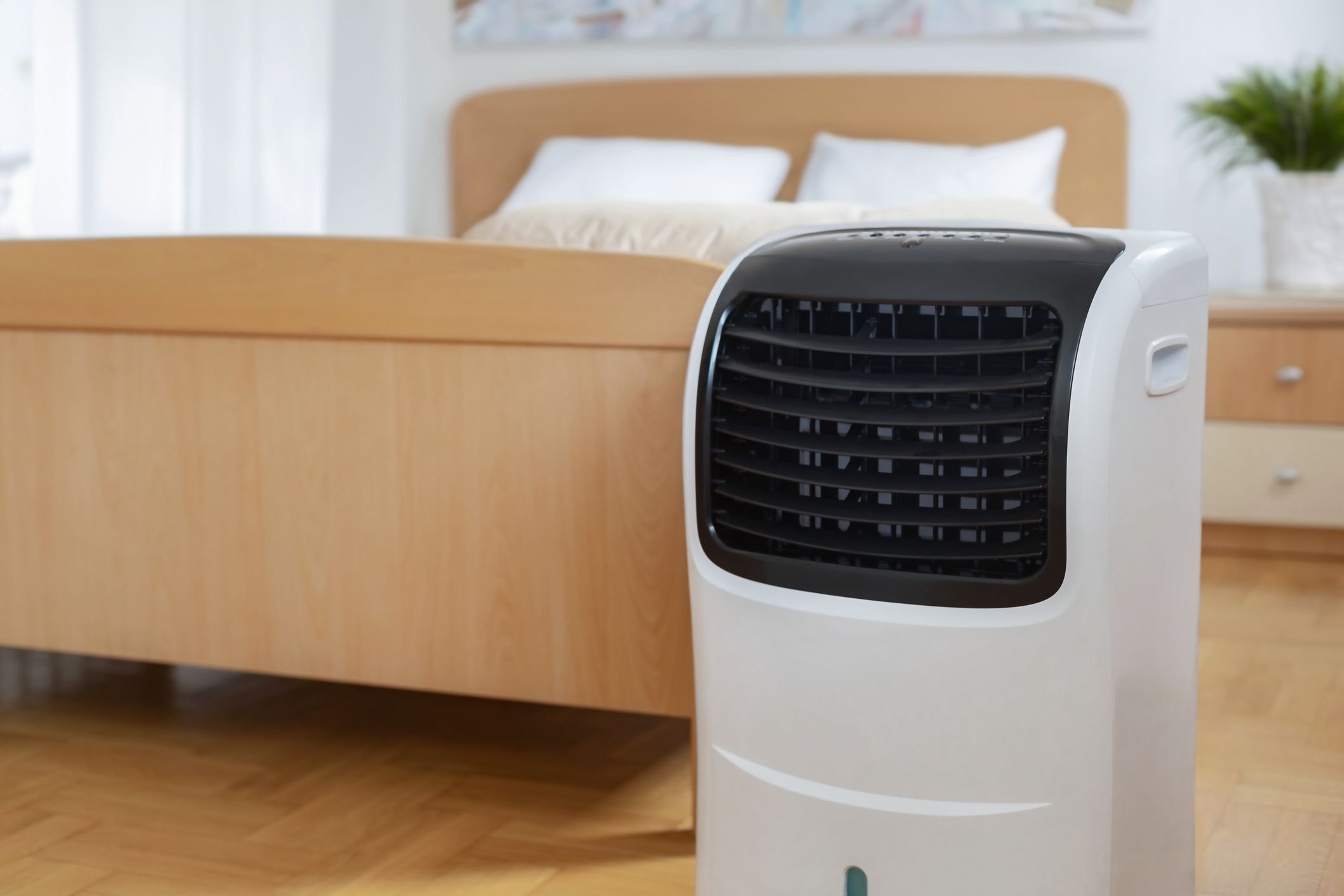 Portable mobile air conditioner stands in the bedroom at home copy space