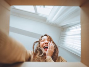 Surprise excited asian woman opening gift box, Inside view of carton box bottom, Satisfied client, positive feedback. Delivery and online shopping concept.