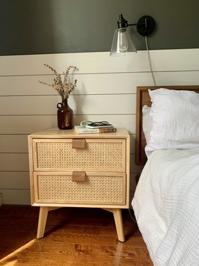 The rattan nightstand holds a surprising amount for its compact size.