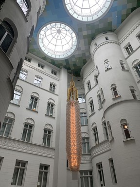 The atrium lounge in Nobis HOtel, complete with an 82-foot ceiling and a 22-foot chandelier made from thousands of small crystals.