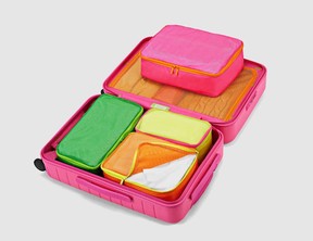 Packing cubes in a Paradise Pink suitcase.
