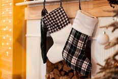Festive stockings hanging on fireplace at Christmas
