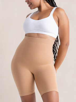 Woman wears tan shapermint Essentials All Day Every Day High-Waisted Shaper Shorts
