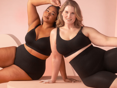 black and white woman sit together wearing black shapewear undergarments