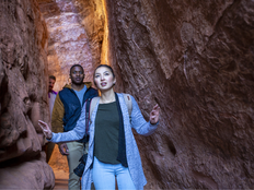 Hikers walk through red rock canyons in Zion National Park