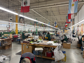 A general shot of the factory that features flags of the countries where workers originated.