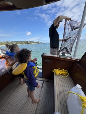Dropping our crab trap at a swimming stop.