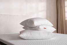 Stack of pillows on a bed.