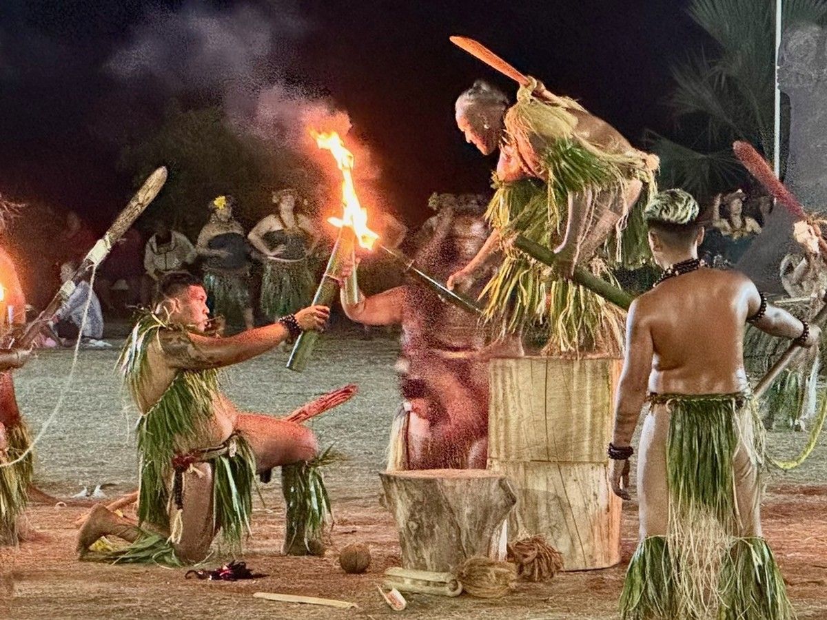 Male dancers from the island of Nuku Hiva perform the dance of fire.