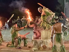 Male dancers from the island of Nuku Hiva perform the dance of fire.